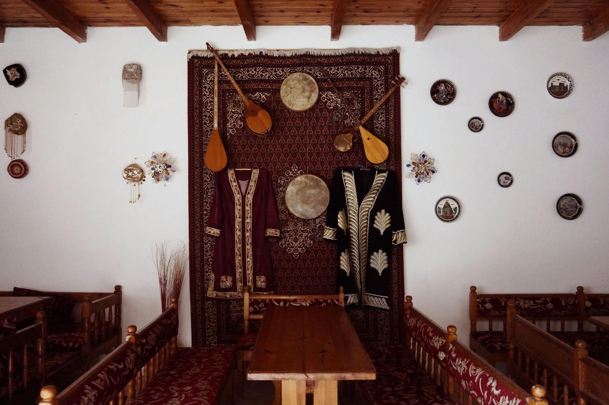 Cozy interior adorned with traditional musical instruments and cultural decor.