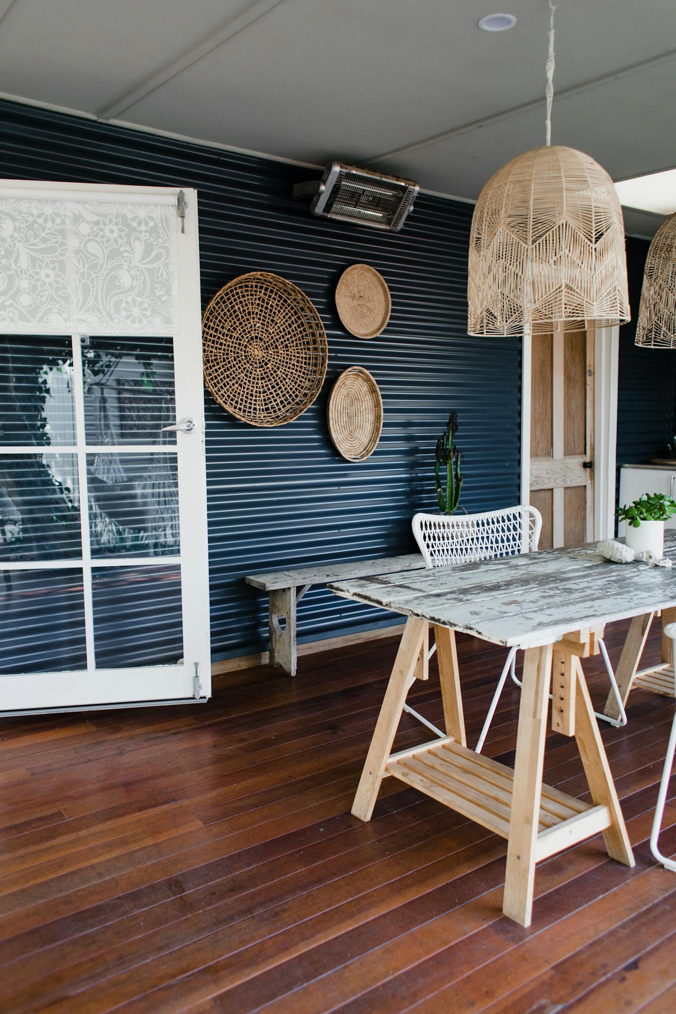 Elegant patio with wooden furnishings and decorative elements, perfect for a cozy indoor-outdoor feel.